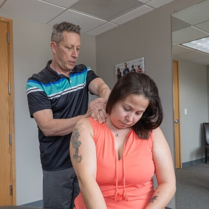 Dr Glenn adjusting patients neck
