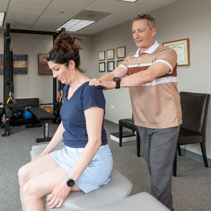 Dr Glenn adjusting patients shoulders