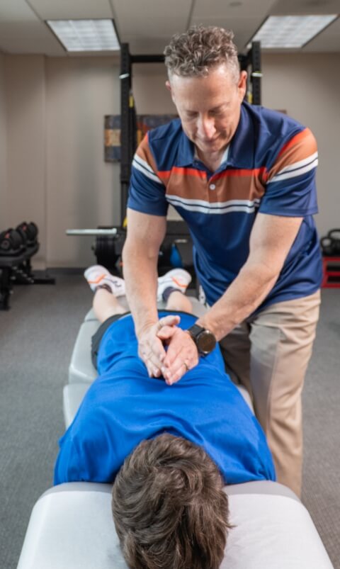 Dr Glenn adjusting patients back