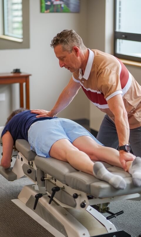 Dr Glenn adjusting patients lower back