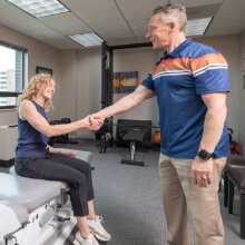 Dr. Glenn shaking patients hand
