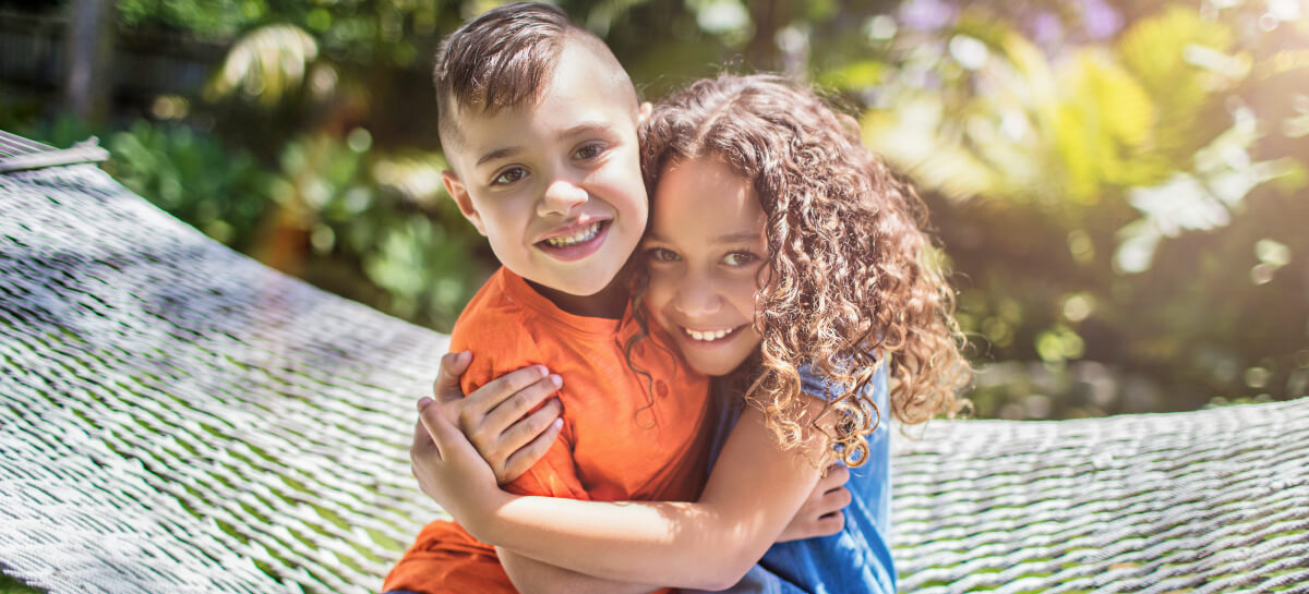 Young brother and sister hugging each other