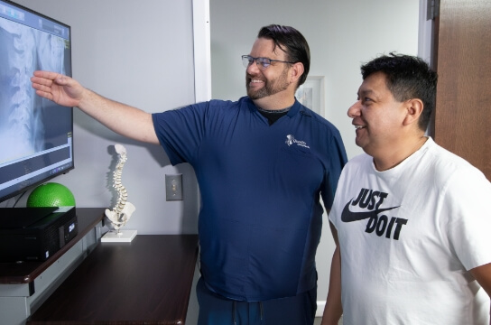 Falls Church chiropractor discussing x-ray results with patient