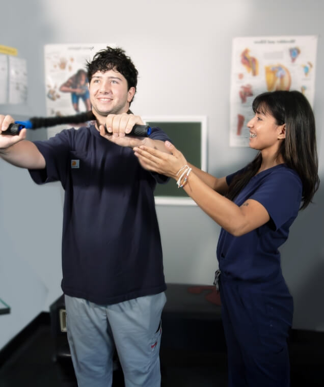 Quality Chiropractic staff assisting patient with recovery exercises