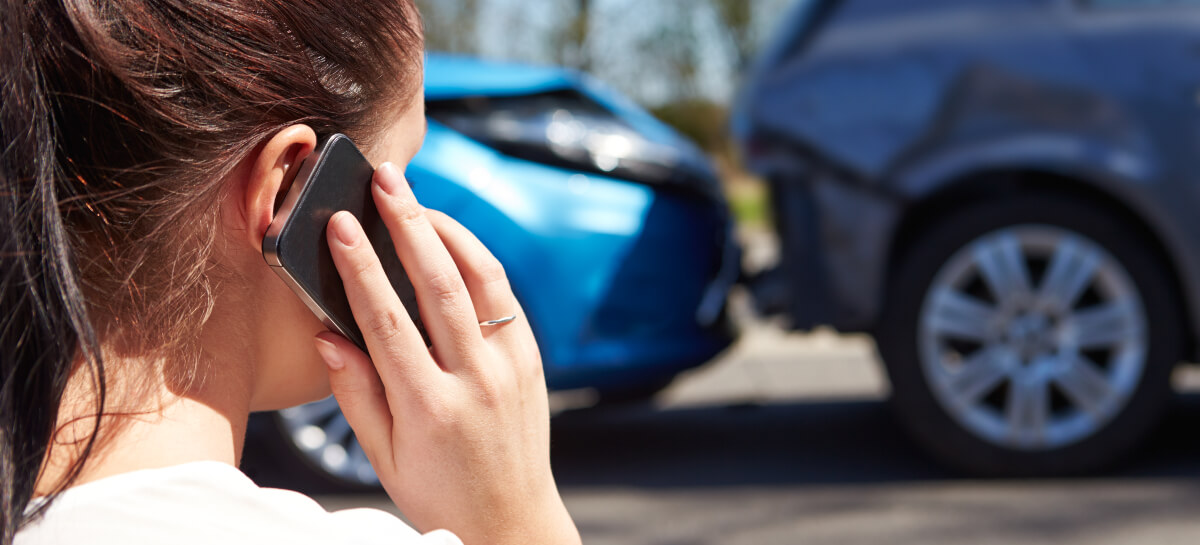 Woman making a call after a car crash