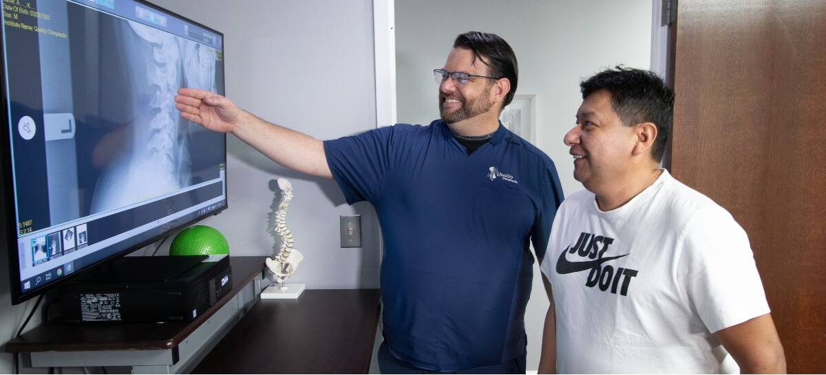 Falls Church chiropractor discussing x-ray with patient