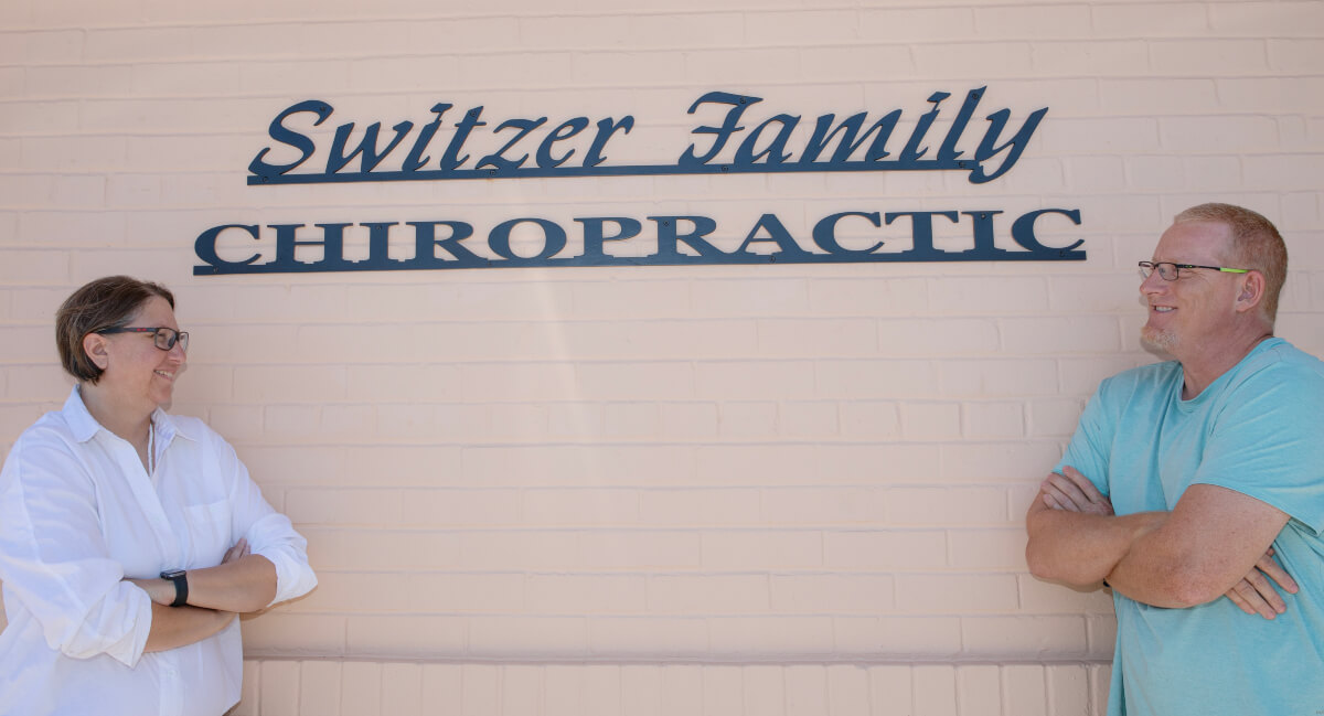 Switzer Family Chiropractic team standing in front of practice signage