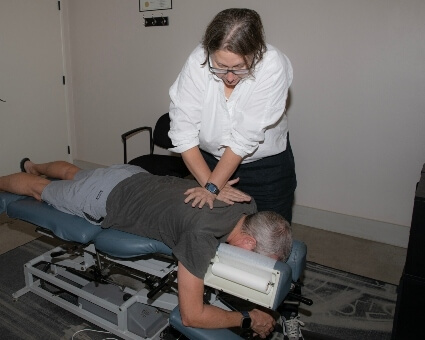 Male patient receiving chiropractic adjustment at Switzer Family Chiropractic