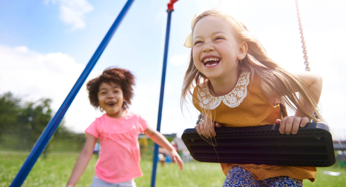 Young girls playing on a swing