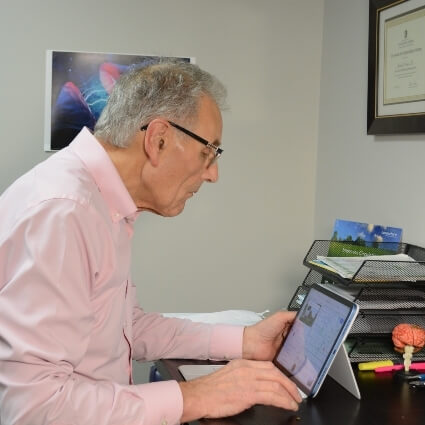 Everett chiropractor Dr Michael looking at ipad