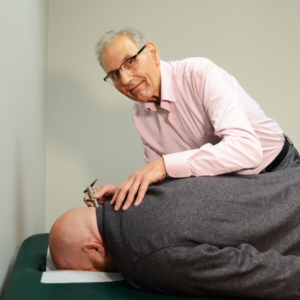 Everettc hiropractor Dr Michael adjusting practice member