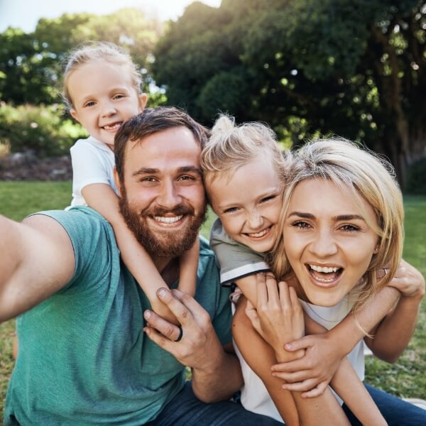family of 4 smiling together