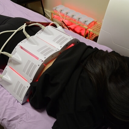 red light therapy belt on persons back