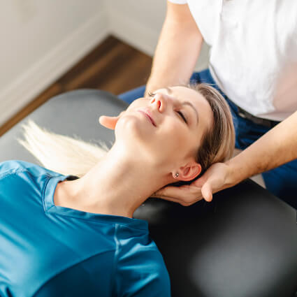Chiropractor adjusting patient's neck
