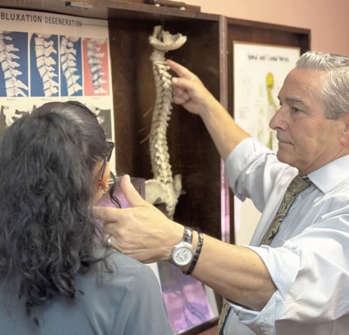 Chiropractor holding patient's arm