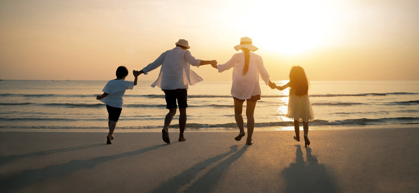 family of 4 on the beach at sunset