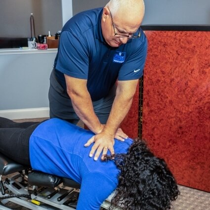 Webster chiropractor Dr Page adjusting patients neck