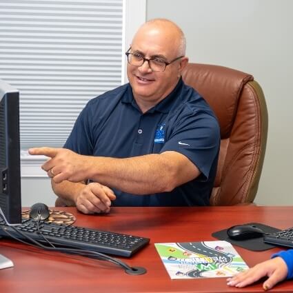 Webster chiropractor pointing at computer screen