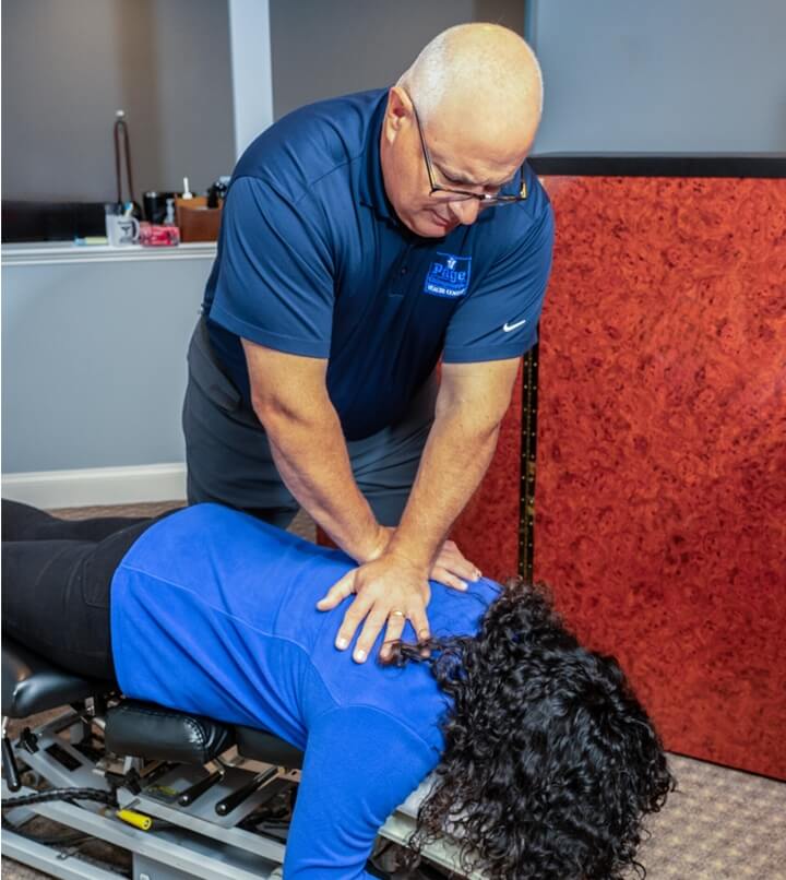 Webster chiropractor Dr Page adjusting patients neck