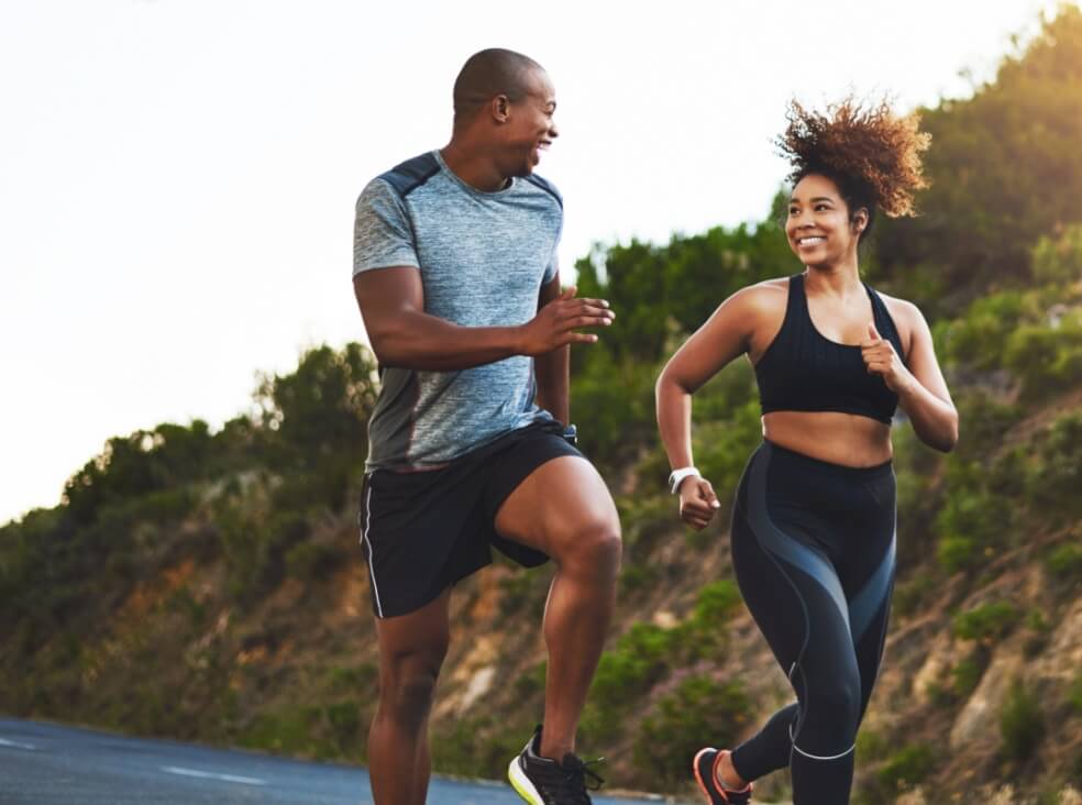 man and woman running outdoors