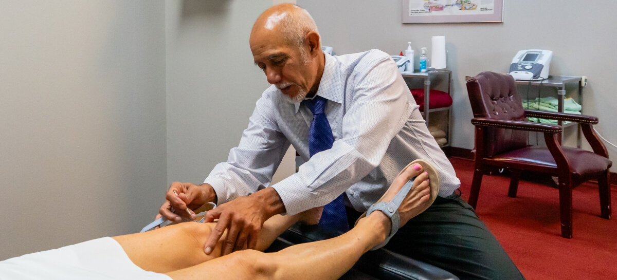 Dr. John Scott treating patient with acupuncture