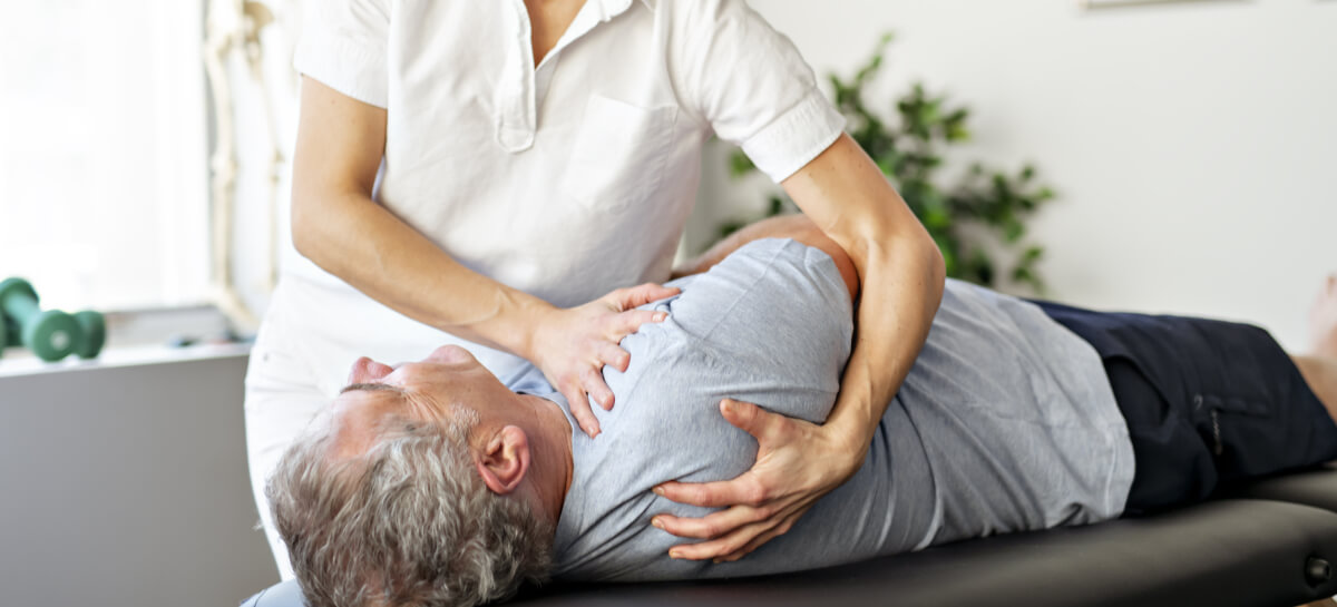 Female chiropractor adjusting a patient