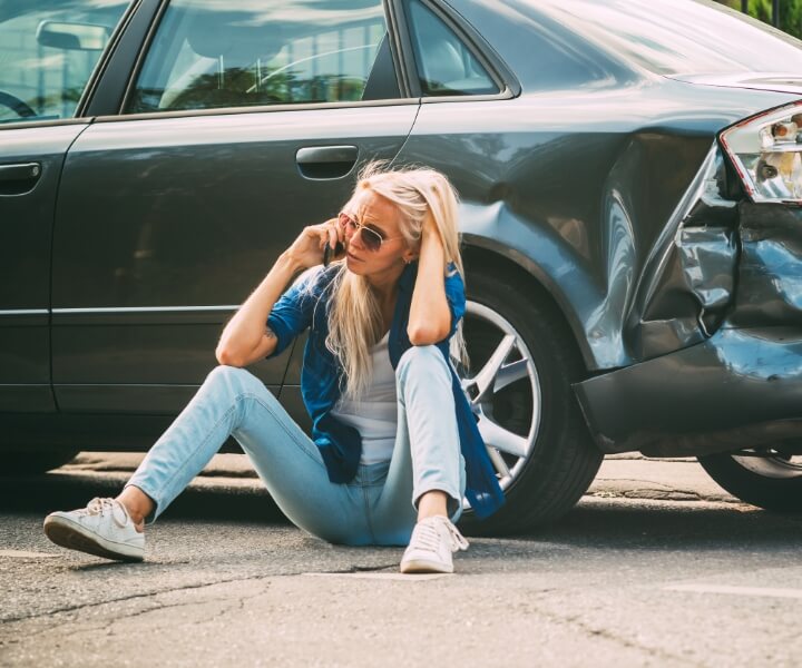 woman on phone after car accident