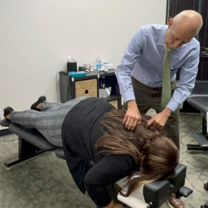 Chiropractor adjusting patient's back