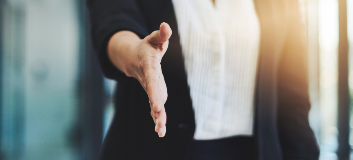 Businesswoman reaching out for handshake