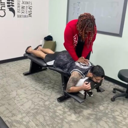 Male patient receiving a chiropractic adjustment