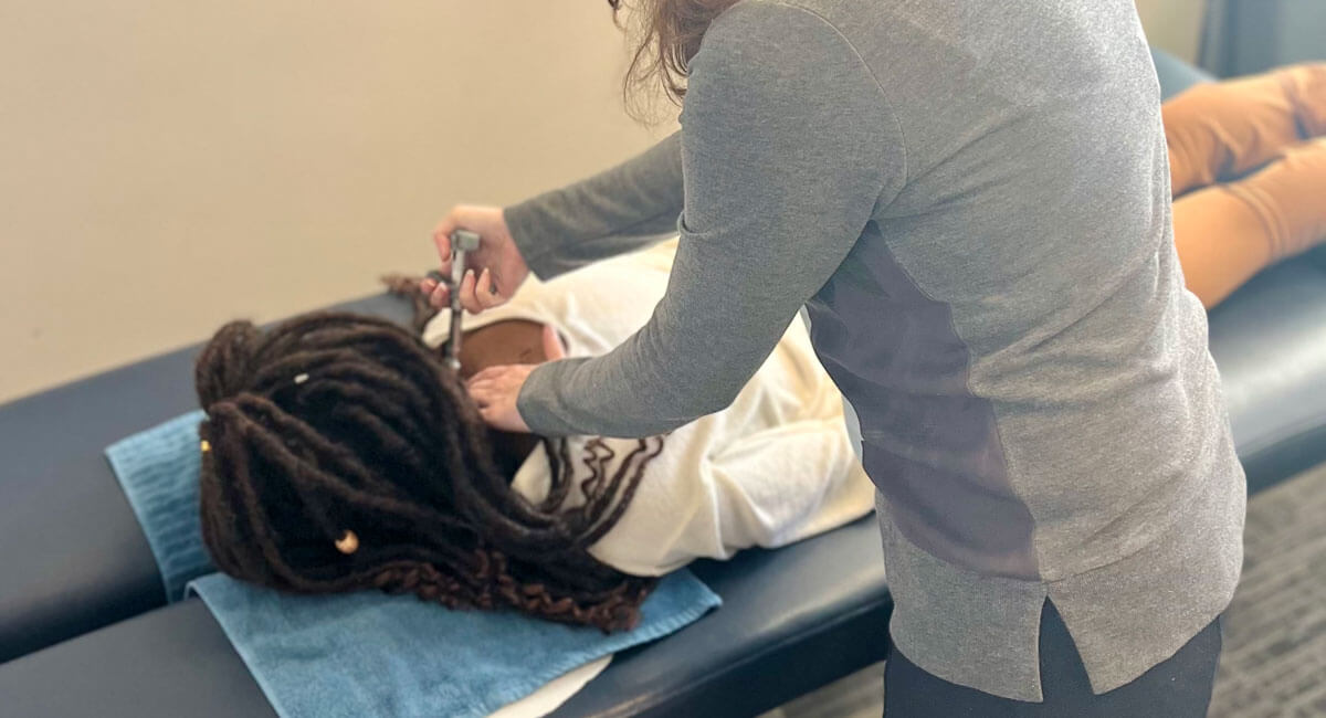 Calgary Chiropractor Dr. Jackie using Activator for adjustment