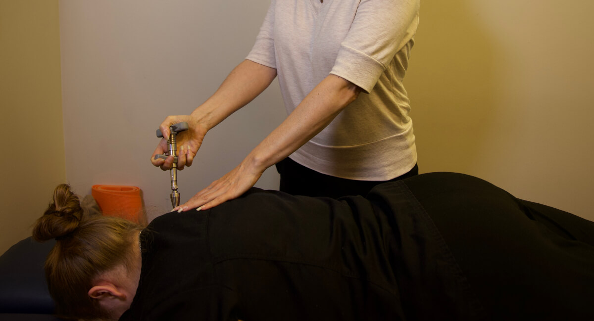 Calgary Chiropractor Dr. Jackie using Activator for adjustment
