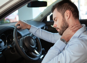 man holding neck after auto accident