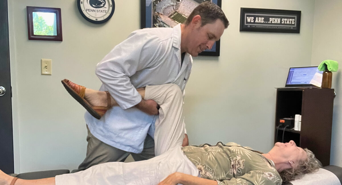Chapel Hill chiropractor stretching patient's leg
