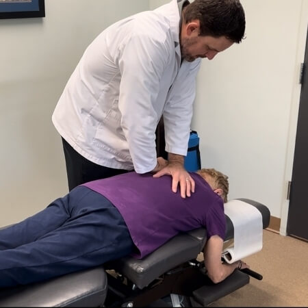 Chapel Hill patient receiving a chiropractic back adjustment