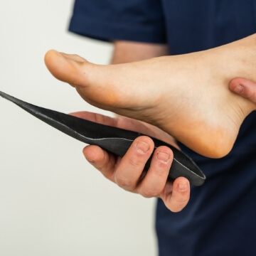 Female patient getting fitted for orthotics