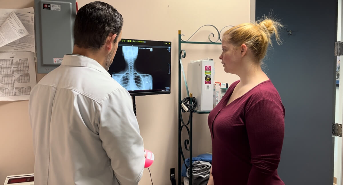 Chapel Hill chiropractor reviewing x-ray with female patient