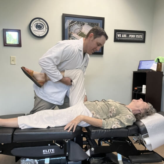 Chapel Hill patient receiving a chiropractic leg adjustment