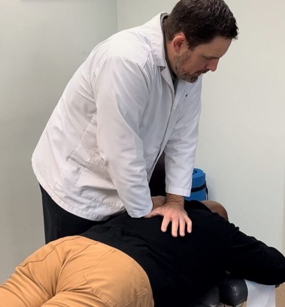 Chapel Hill chiropractor adjusting patient's back