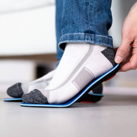 Man fitting orthotics
