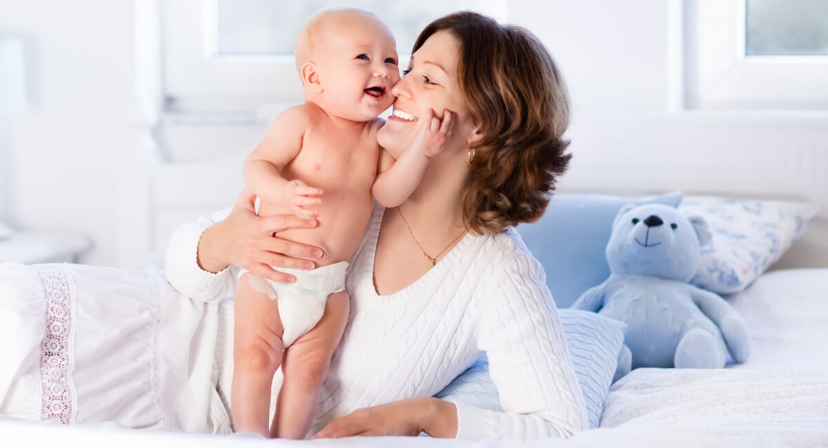 Smiling mom and young baby