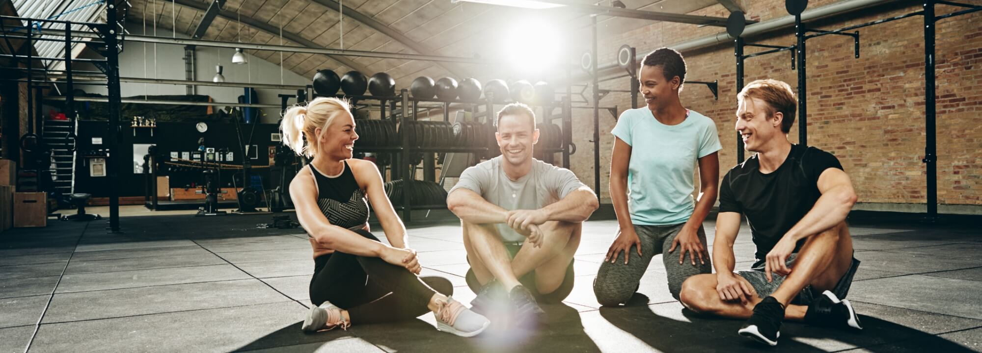 Men and women laughing at the gym