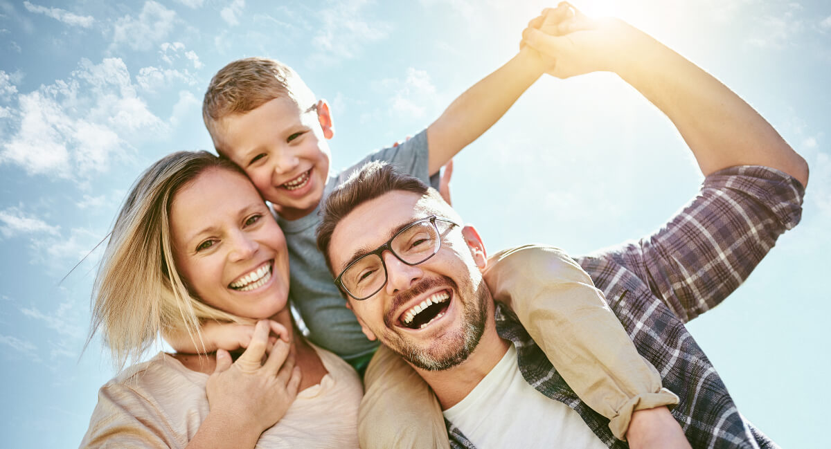 Smiling family of three