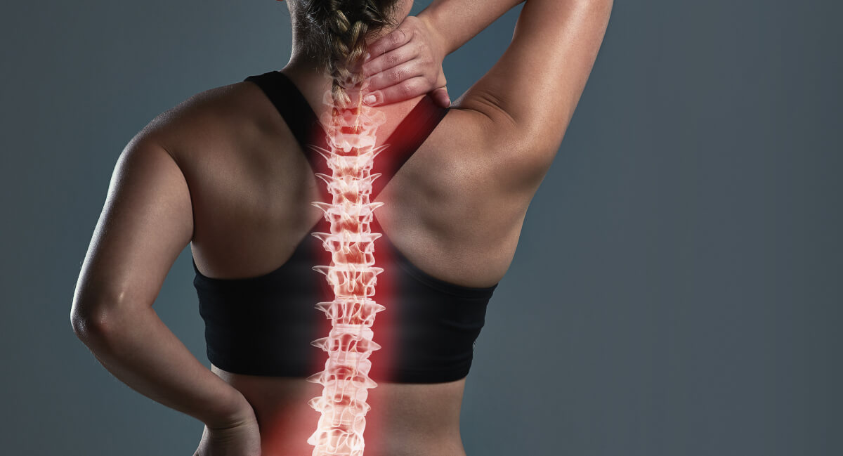 Spine illustration on female patient's back