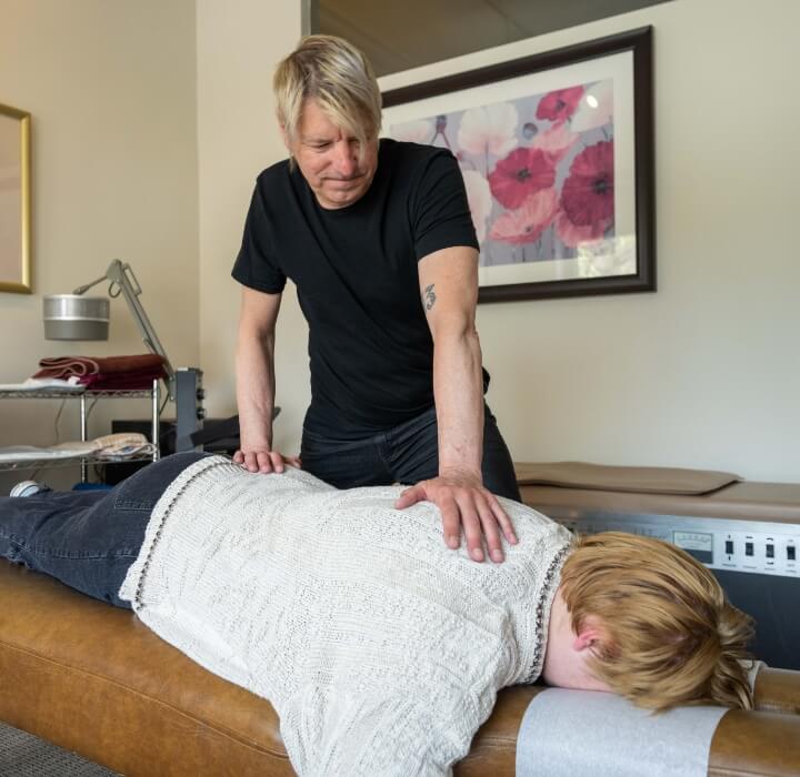 Noel massaging patients back