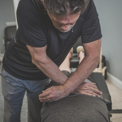 Morehead chiropractor Dr Tim adjusting patients back