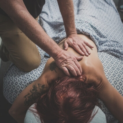 patient having back massaged