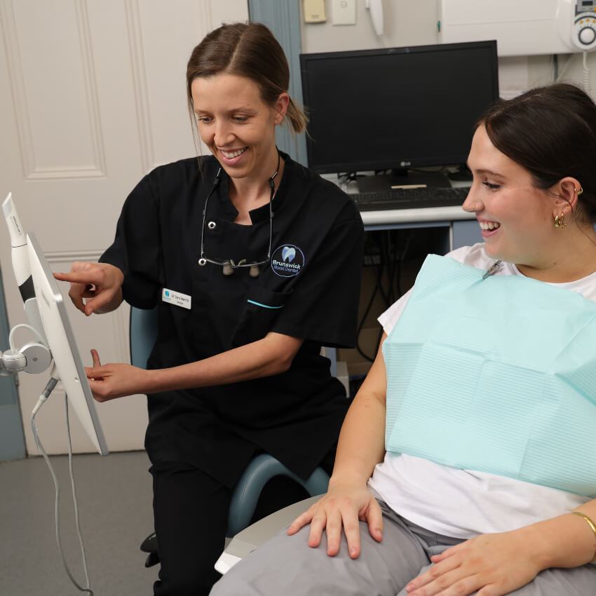 Brunswick dentist Dr Sara talking with a patient