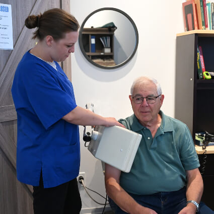 laser therapy tool on persons arm