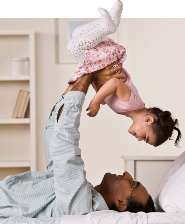 father and daughter playing on couch
